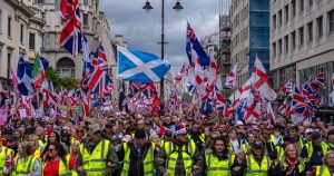 Thousands hit London streets for “Unite the Kingdom” march organized by far-right activist Tommy Robinson